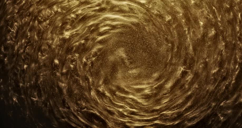 Golden grains of sand swirl in circle