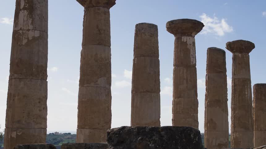 Old greek ruins standing against a blue sky