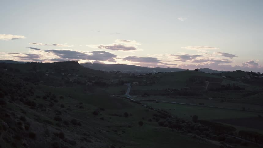 Clouds float over a rural area at sunset