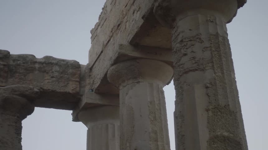 Ancient stone pillars at sunset