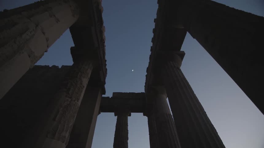 Weathered stone pillars at night