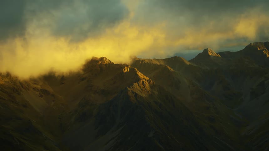 Clouds are moving across the top of a mountain range