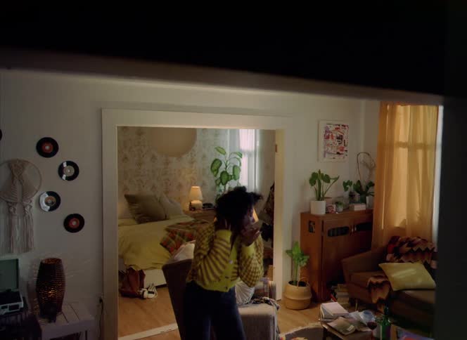 A woman is dancing in the living room