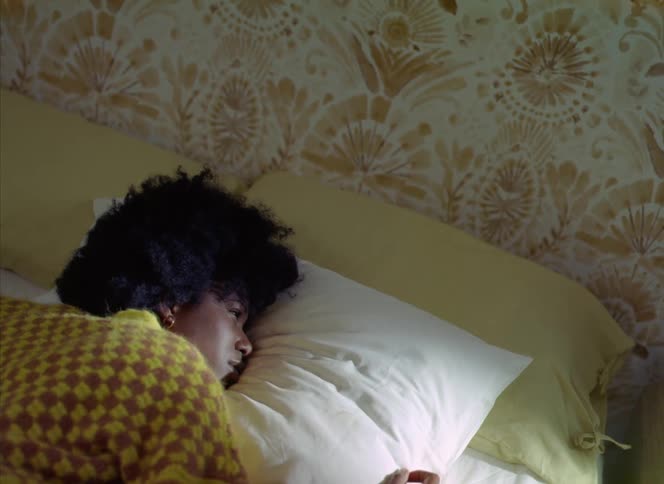 A woman rolls over after waking up