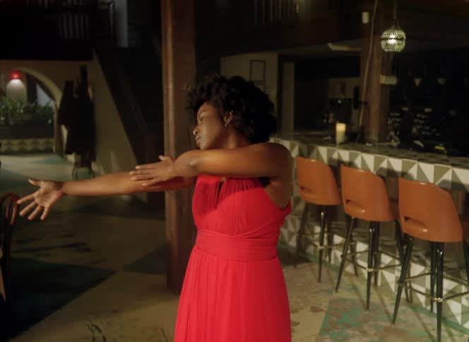 A woman dances in a large dining room