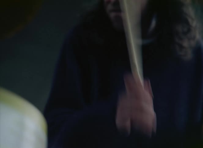 A man is drumming really fast on a drum