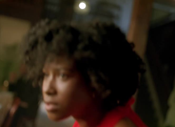 Close up of the face of a woman feeling the rhythm and starts dancing inside a restaurant
