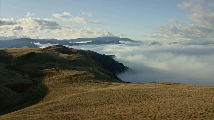 Aerial view of a cloudy landscape is displayed