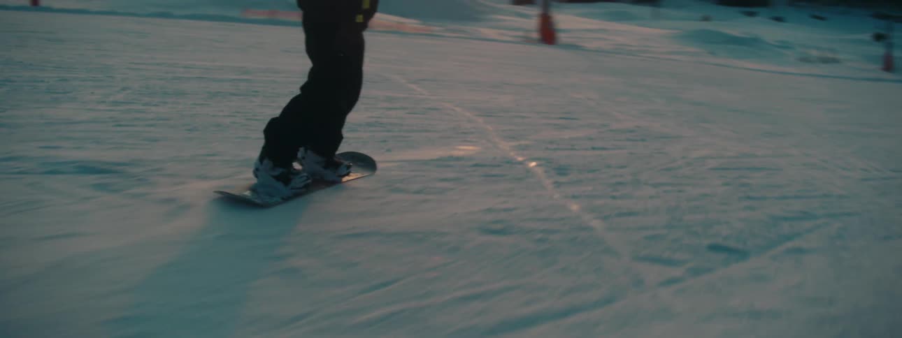 A person snowboards down a mountain
