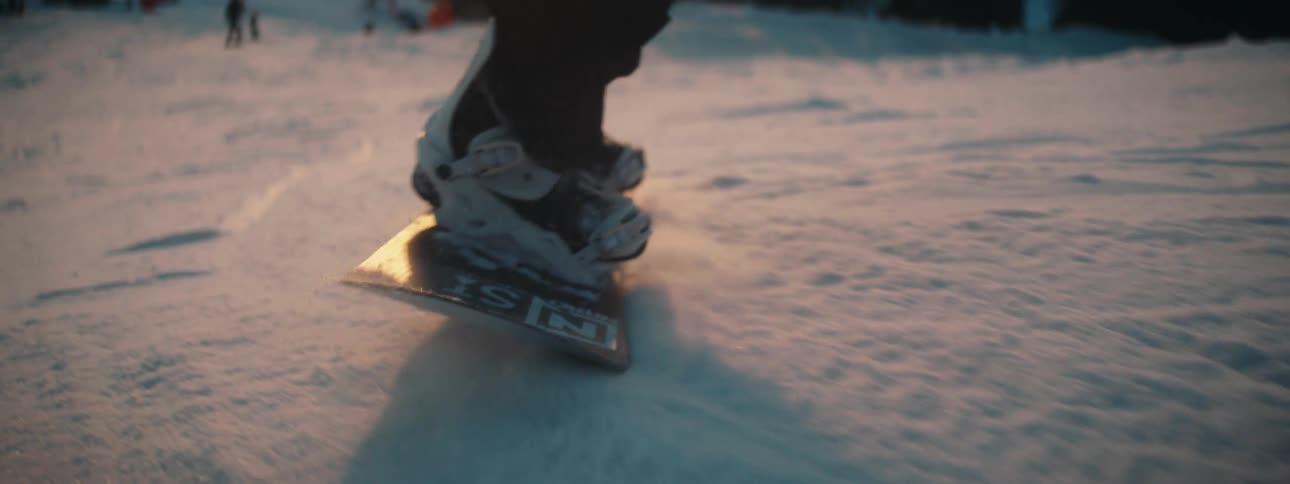 A person snowboards down a mountain