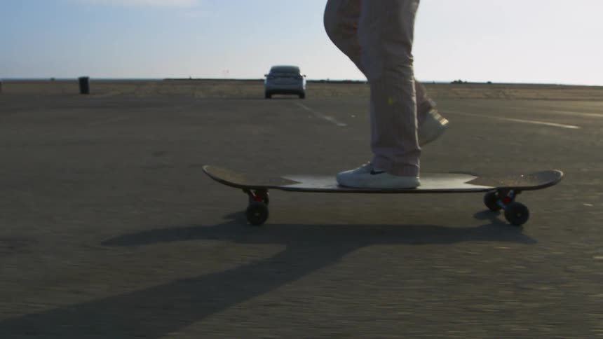 A person is skateboarding outdoors during midday