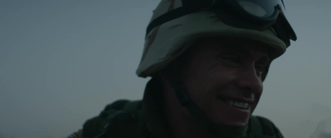 Soldier with helmet goggles and uniform talks and laughs