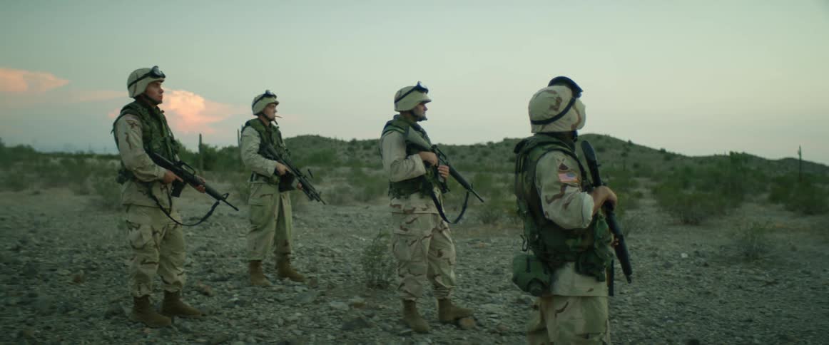 A group of soldiers with guns outdoors