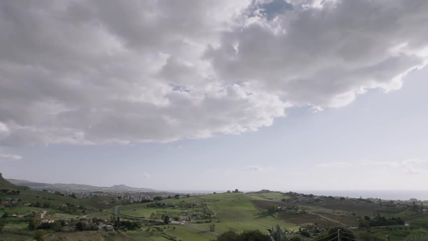 Clouds over green fields
