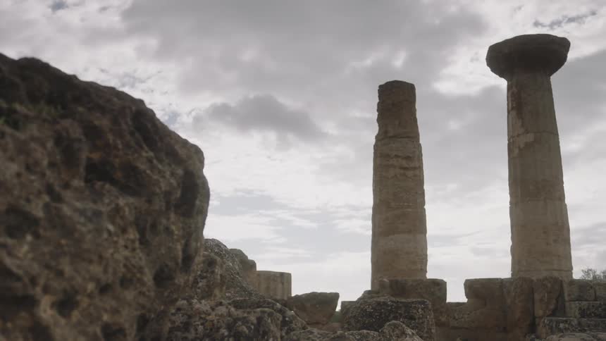 Clouds float over old pillars