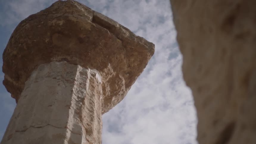 A stone pillar towers overhead