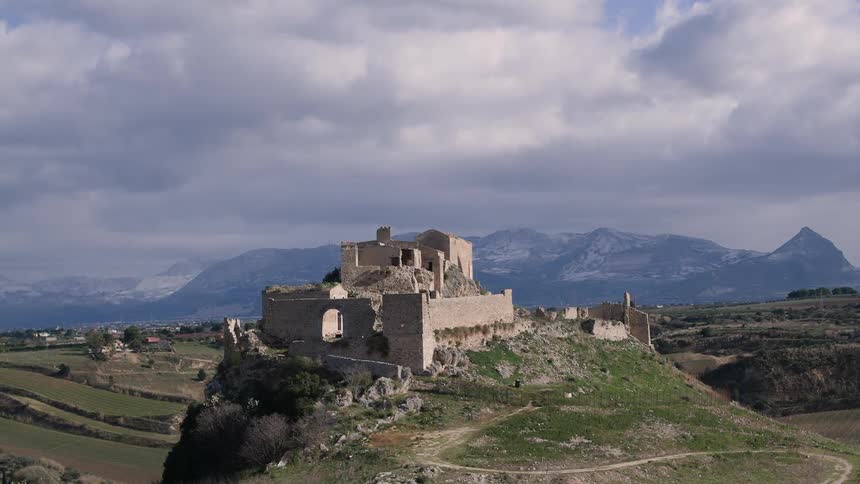 A castle sits on a hill on a cloudy day