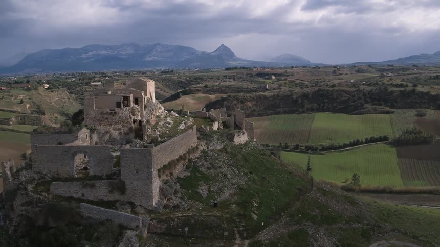 An aerial view of a ruined monastery on a hilltop
