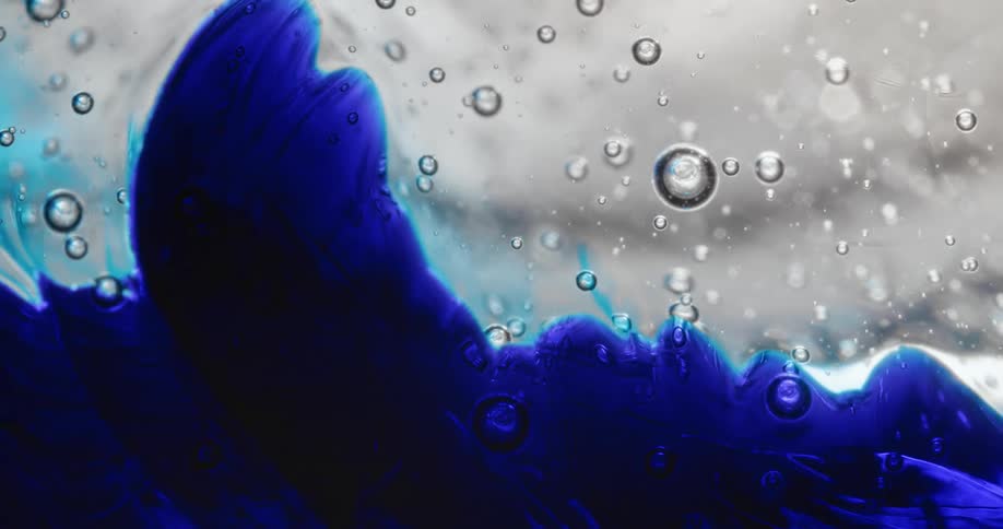 Bubble spheres float across a blue and white organic environment