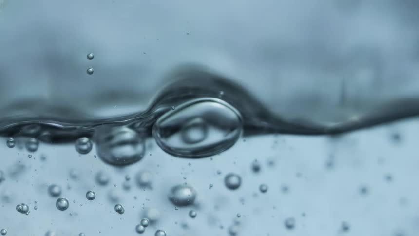 Air bubbles form in water in a container
