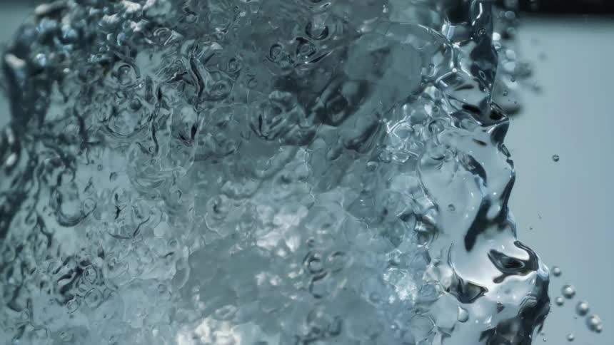 Water surges through the surface splashing upwards