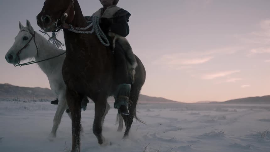 Man riding horse through a snowy wilderness