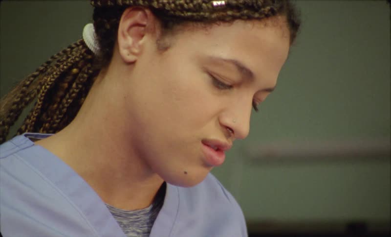 There is a nurse that is working at a office in the day time