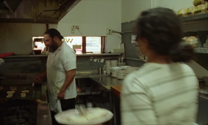 People are working at a restaurant and are preparing food