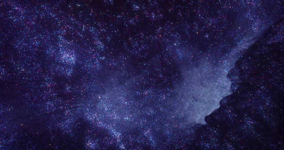 Bright blue glittering specks floating on a dark background flowing in slow waves