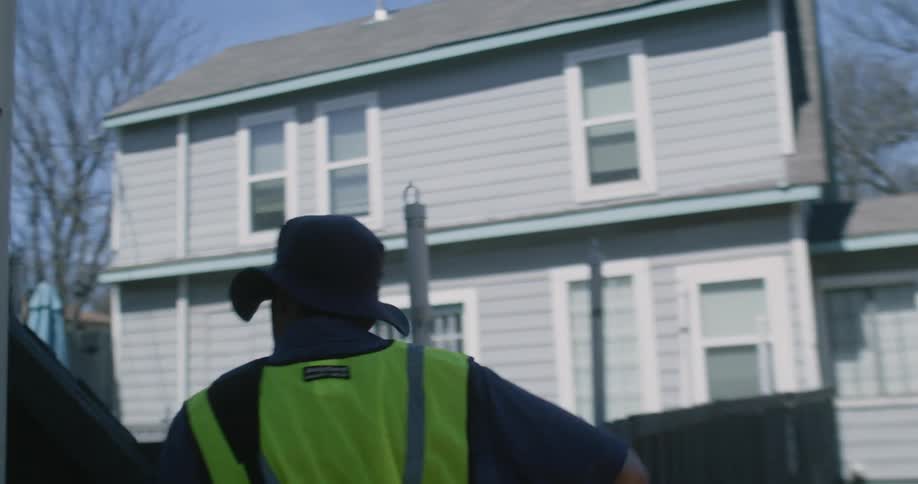 A man is delivering a package to a home