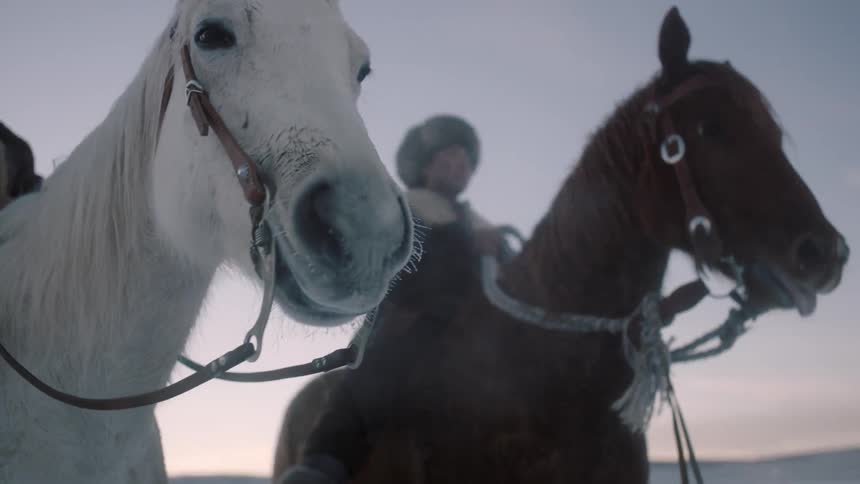 Explorers on horses in a cold climate