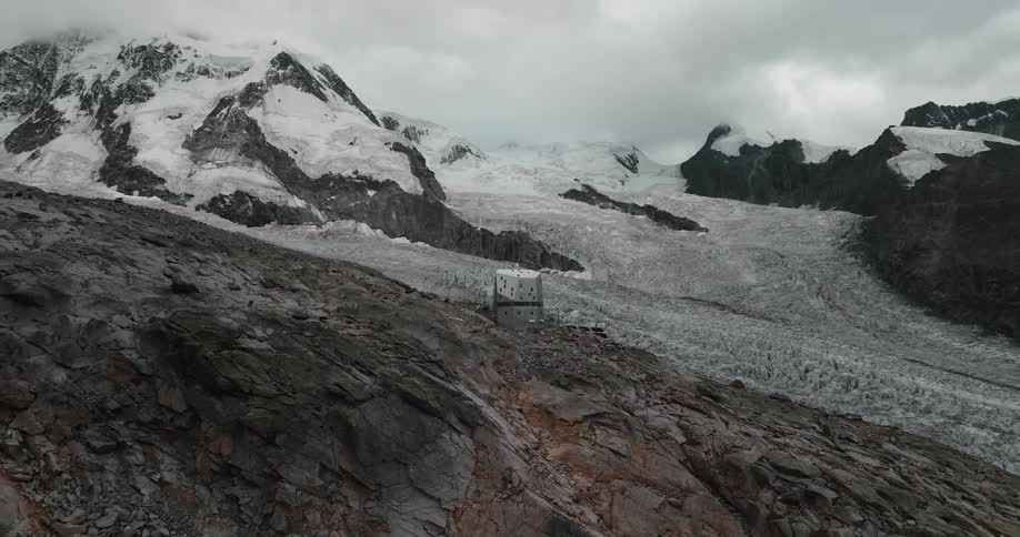 Camera slowly pans back from a snowy mountainous area