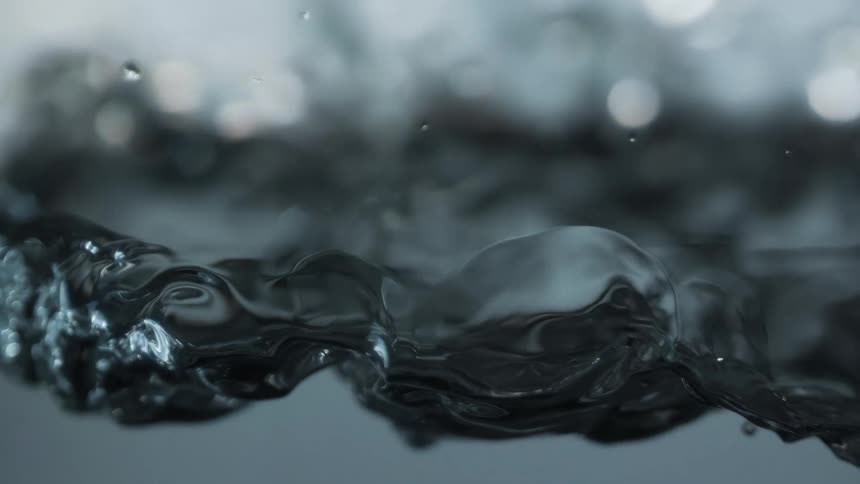 Close up view of water surface moving as it ripples and bubbles