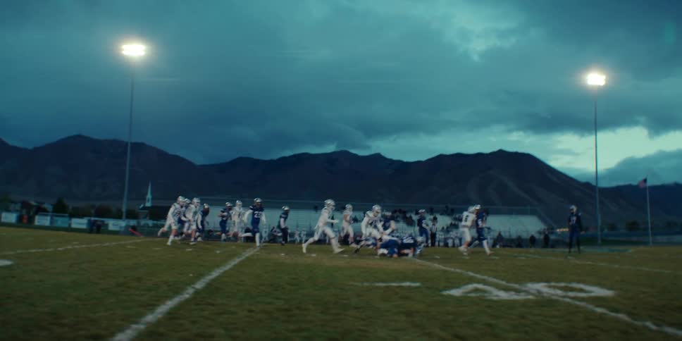 Football players run on the field