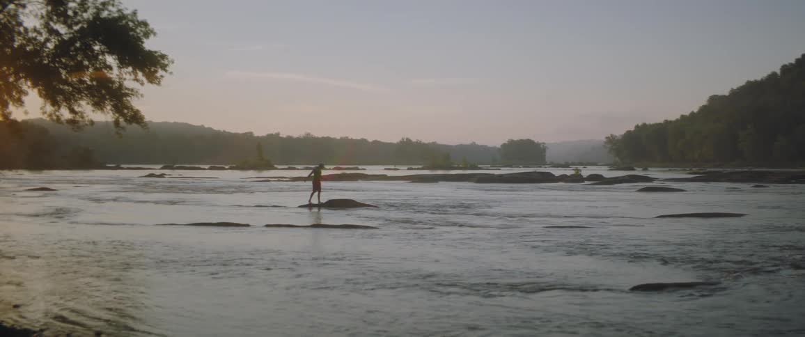 A man is crossing the river