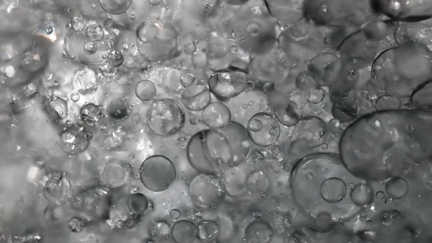 Many bubbles reflect light as they move and float