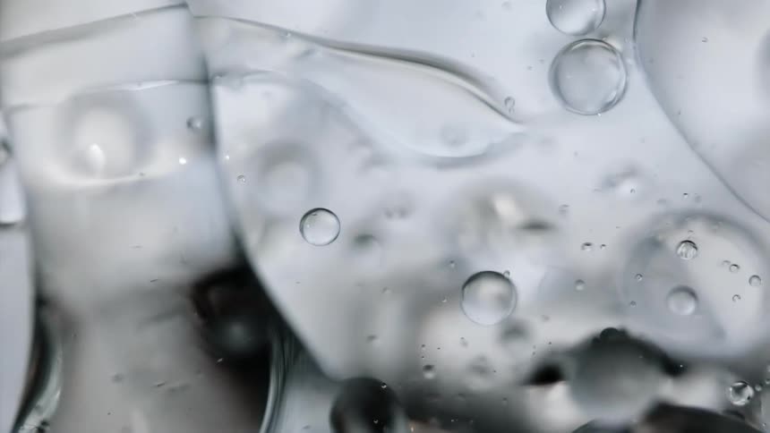 Bubble spheres are floating in a liquid as they reflect light