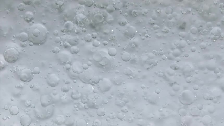 Bubble spheres are floating in front of a white area