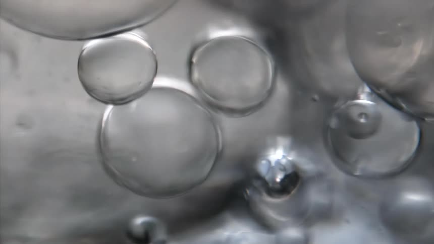Bubble spheres are floating in a liquid and reflect light as they move