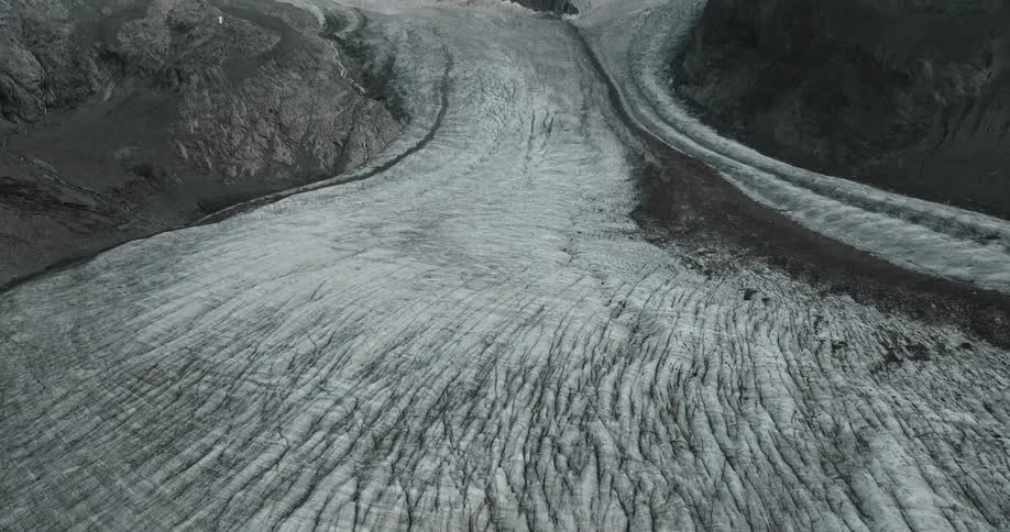 An aerial view of a snowy mountain landscape in winter