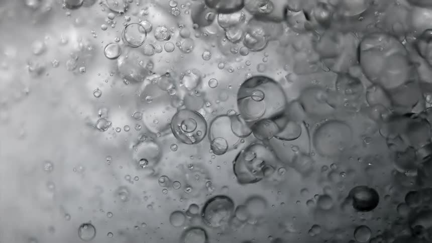 Light shines on bubbles in the water as they float and move