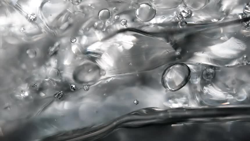 Bubble spheres are floating in a liquid as they reflect light