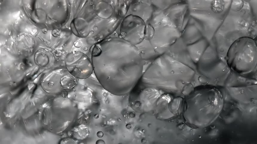 Bubbles in clear liquid rise and fall with surface waves