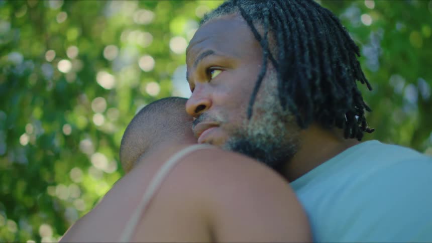 A couple hug outside