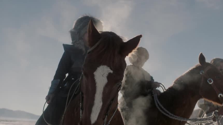Men sitting on horses in a wintry landscape