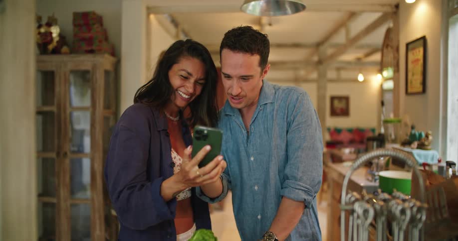 A couple look at a cell phone together