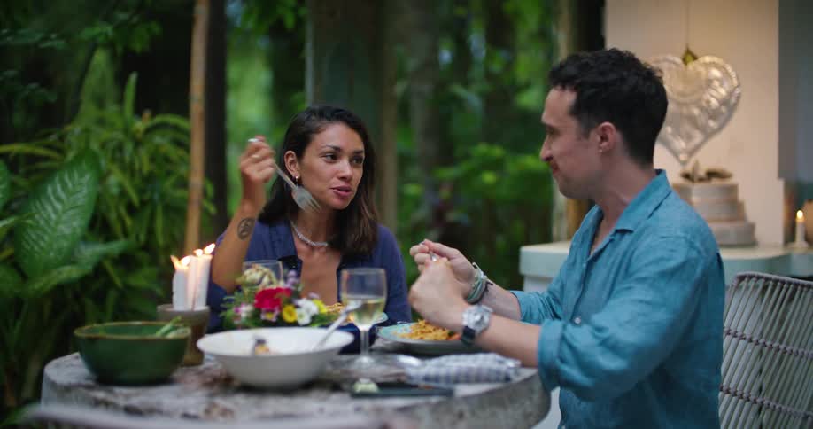 A couple have dinner outside