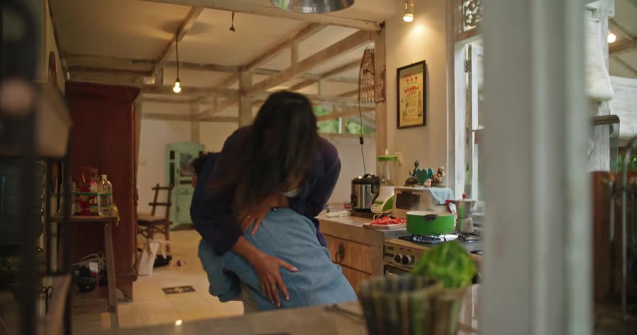 A couple dance together at home