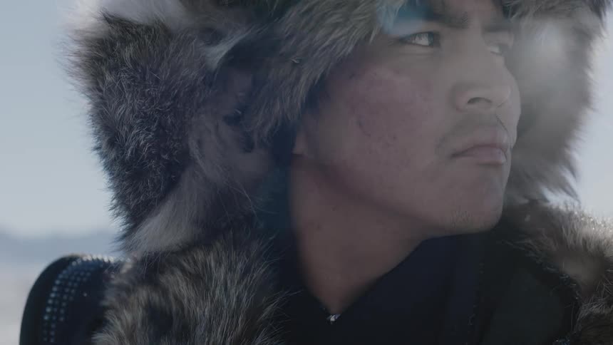 A man in a fur hat looks around