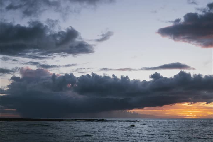 The sun sets and rises over the ocean